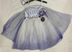 This satin dress features diamond glitter detailing, and an attached glitter cape. The full skirt contains a special...