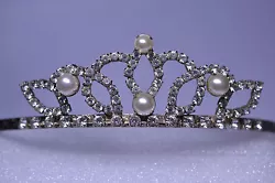 This is a rhinestone and faux pearl tiara with engraved sides and two attached combs. All the rhinestones are bright...