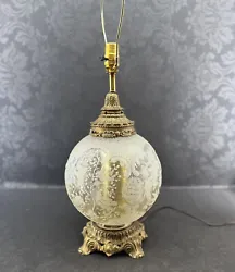 It has the most attractive frosted glass globe sitting on top of a brass base. It is in excellent condition.