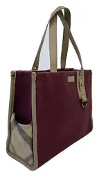 Material: Canvas and leather. Adjustable strap, open top. The interior features one zip pocket snd two open pockets....