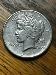 This key date 1921 Peace Dollar has been cleaned at some point but it’s still a bad mamma jamma.