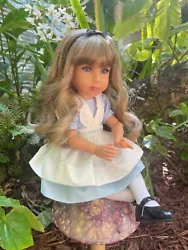 Her ash-blonde removable wig is silky long with soft waves and bangs. A sculpt by master doll artist Dianna Effner and...