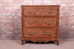 An exceptional French Provincial Louis XV style chest of drawers or commode. Carved oak, with burl wood top and...