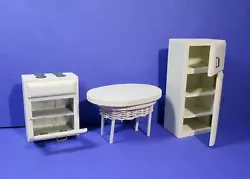 3 pc of doll furniture: a table, a stove with an oven, and a fridge.