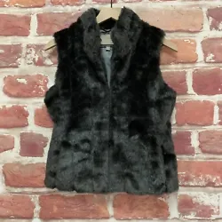 Mock neckline, hook and eye front closure, faux fur, fluffy texture, side pockets, lining, and sleeveless. Wear it with...