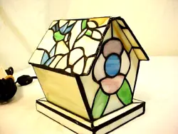 Stained glass birdhouse electric lamp nightlight. Works well with minimal usage noted. Bright colors with no issues....