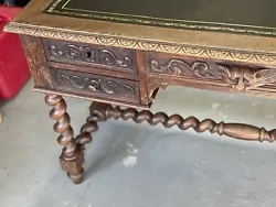 This antique desk is a magnificent piece of furniture, crafted in the 19th century with exquisite attention to detail....