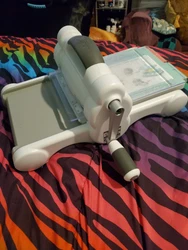 sizzix big shot machine & accessories, including various dies, paper, and more. also included are some projects cut out...
