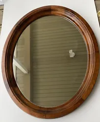 Classic oval wooden midcentury wall mirror. It displays well, and would add to any traditional or midcentury room. The...
