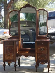 Antique vanity with trifold mirror.