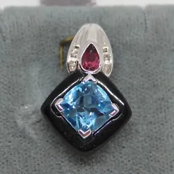 Blue topaz gemstone and diamond accents. Also has a pink stone but I am not sure what gemstone it is. 15.5 mm wide....
