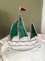 Beautiful stained glass nautical sail boat sun catcher.  Top flag is red, all sails are green and boat body is...