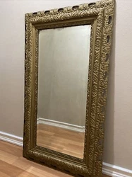 Beautiful ornate antique gold tone wood frame and large mirror. Hand carved wood in a syroco style, highly detailed....