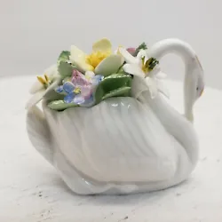 Royal Dalton Swan With Flowers  The pre-loved swan is in very nice condition. I did find the tiniest chip on one of the...