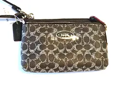 COACH SIGNATURE DOUBLE CORNER ZIP. DOUBLE ZIP TOP CLOSURES. EMBOSSED SIGNATURE COATED CANVAS WITH LEATHER TRIM.