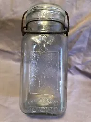 Beautiful clear glass Queen trademark wide mouth canning jar adjustable . With lid , no chips . Wire is rusted a little...
