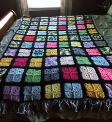 Beautiful crochet granny square afghan with fringe trimming on each end. In very good condition.
