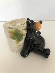 BLACK BEAR AND TREE STUMP SALT AND PEPPER SHAKERS. APPROX 3”X3.25” AND 3”X2”.