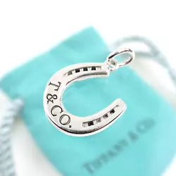 Tiffany & Co. Stamped: TIFFANY & Co. 925. Tiffany pouch. Material: Sterling Silver 925. Charm size: 15.5mm-W x 16mm-H /...