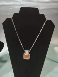 womens necklace beautiful silver toned chain with nice amber gem toned pendant. in new condition