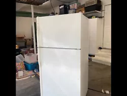 It is a white Kenmore fridge with several shelves and compartments. A few of the doors have faded circles, but overall...