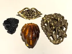 This lot of four dress/sweater clips includes a large brass lily clip that measures 3