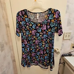 This vintage LuLaRoe T-shirt is a colorful addition to any wardrobe. Featuring a classic neckline, short sleeves, and a...