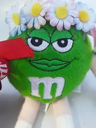 She is holding a bouquet of Flowers with a tiara on head. M & M Green Female Plush. If you love the green M & M...