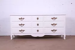 An exceptional French Provincial Louis XV style nine-drawer dresser or credenza. White lacquered carved solid walnut,...