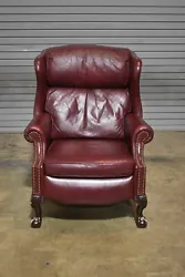 Upholstered in red leather outlined with brass nail heads. Condition Report: Good condition with scuffs and scratches....