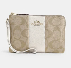 Our Signature canvas with crossgrain leather trim Corner Zip wristlet is perfectly sized for cards, cash and a phone....