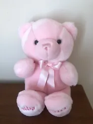 This is a pink teddy bear plush from Aurora with Baby Girl embroidered on the feet.