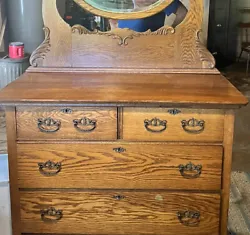 This beautiful antique dresser and mirror is a must-have for any vintage furniture lover. Crafted from solid oak, it...