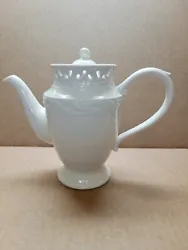 Serve up your favorite hot beverage with the Grace Tea Ware White Porcelain Lace Tea+Coffee Pot. This stunning teapot...