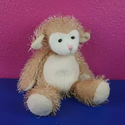 Scraggly monkey with fiber and pellets/beads inside. Plastic eyes.
