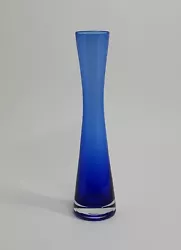 Add a touch of elegance to your home decor with this stunning cobalt blue glass vase. The vase stands at 8 inches tall...