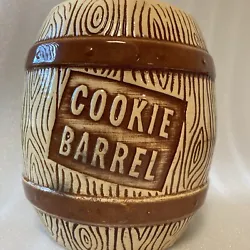The brown color and antique style of this cookie jar make it a unique addition to any kitchen.