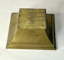 The inkwell is solid brass. The piece is nicely made, but I did not find any makers marks.