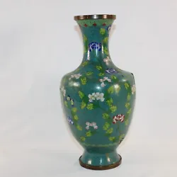 It has four large dents leaving one side worthy of display. There are copper lines throughout the vase.