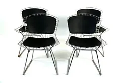 Beautiful matched set of four Bertoia style chairs with black seat and back inserts. Unmarked and sleek and sexy.