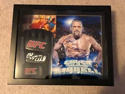 chuck liddell signed photo and glove items are mounted in a shadow box. 