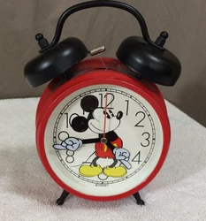 This is a red desk clock featuring Mickey. The clock works BUT THE ALARM DOES NOT WORK.