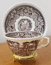 The Transferware is brown and off-white in color. it features a grapevine leaf border and historic scene in the center....