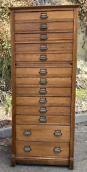 Thirteen drawers. The hardware pulls on the drawers-are very nice. There is a pull out wood writing board in the...