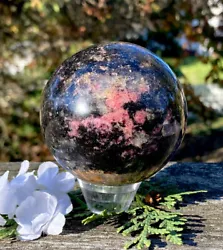 NOTE: The Rhodonite crystal sphere you see in my photos is the exact one you will receive. Rhodonite is believed to...