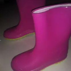 These boots are rubber water proof great for the rain. The color combination is striking.
