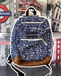 The bag features a zip-around closure and silver hardware material, adding to its durability. It also includes inner...