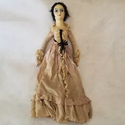I believe her to be from the late 1800s, maybe earlier. Her body, gown, and shoe are hand crafted. Lace trim. The one...
