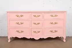 By Kindel Furniture. An exceptional French Provincial Louis XV style nine-drawer dresser or chest of drawers. Pink...