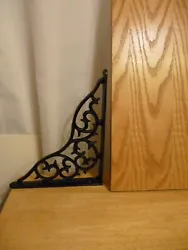One wood shelf with 2 cast iron brackets. The brackets have a leaf design. The wood shelf has 2 grooves but the are not...